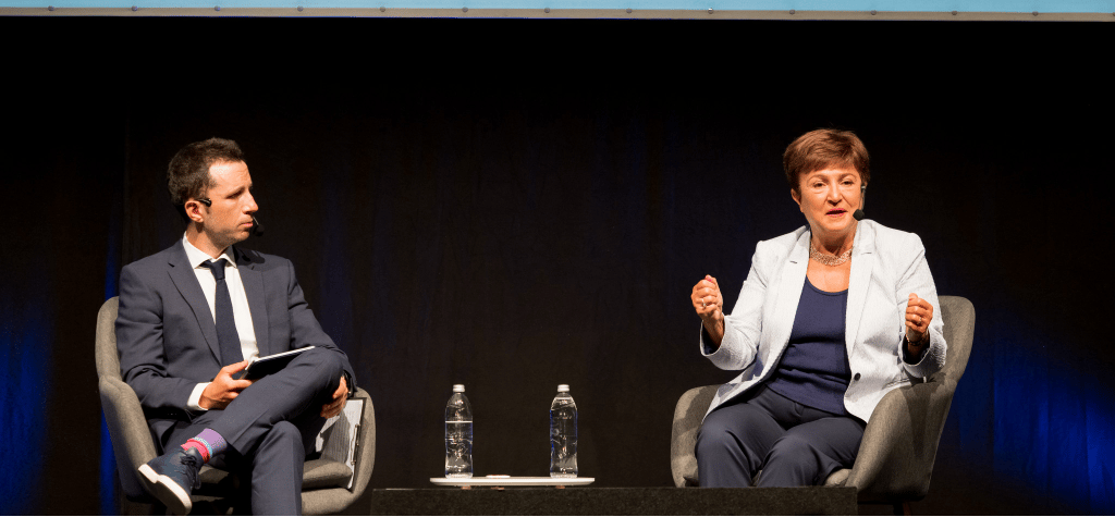 Medium shot photograph of people at a table with awards and items.