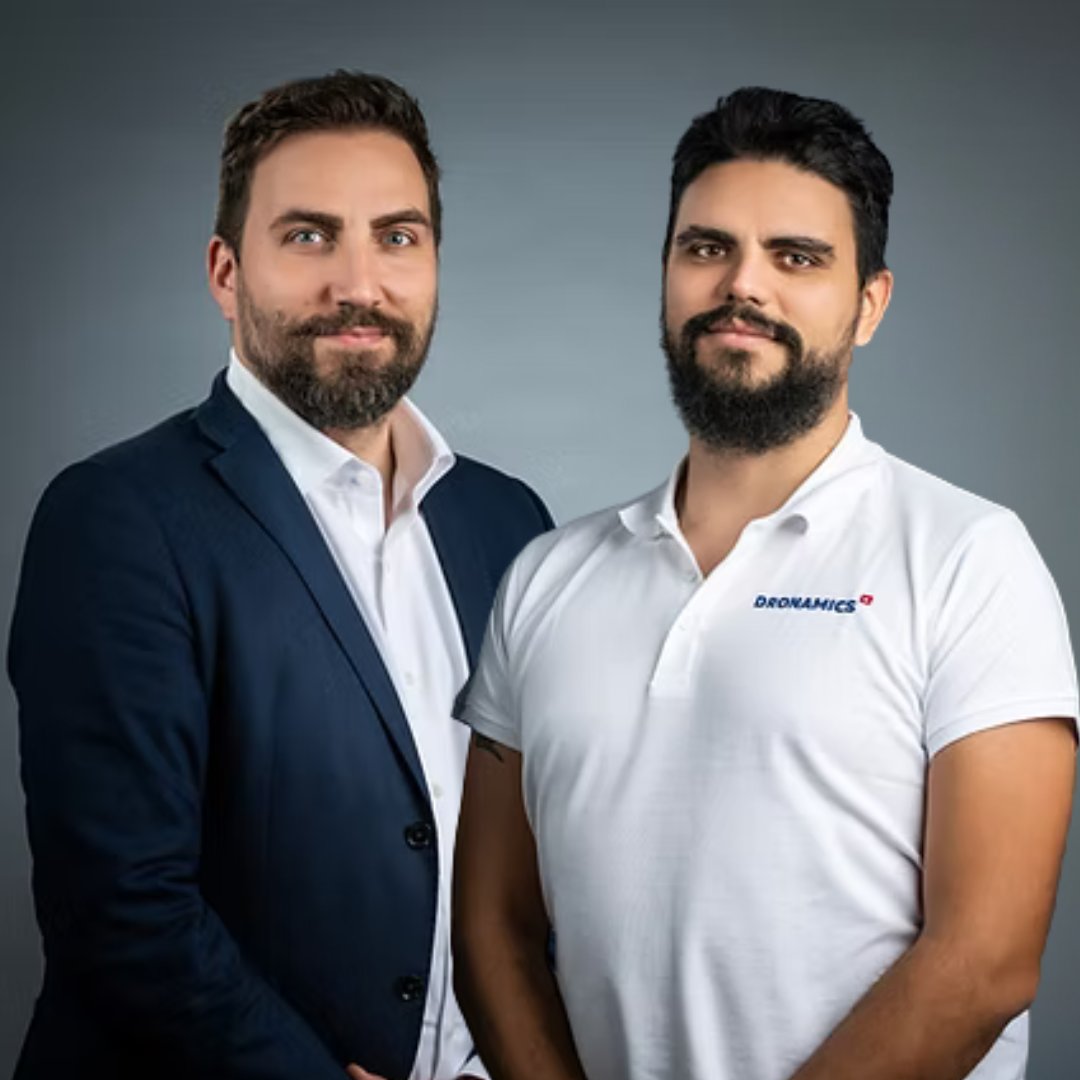 Portrait photograph of a woman with long hair, smiling.