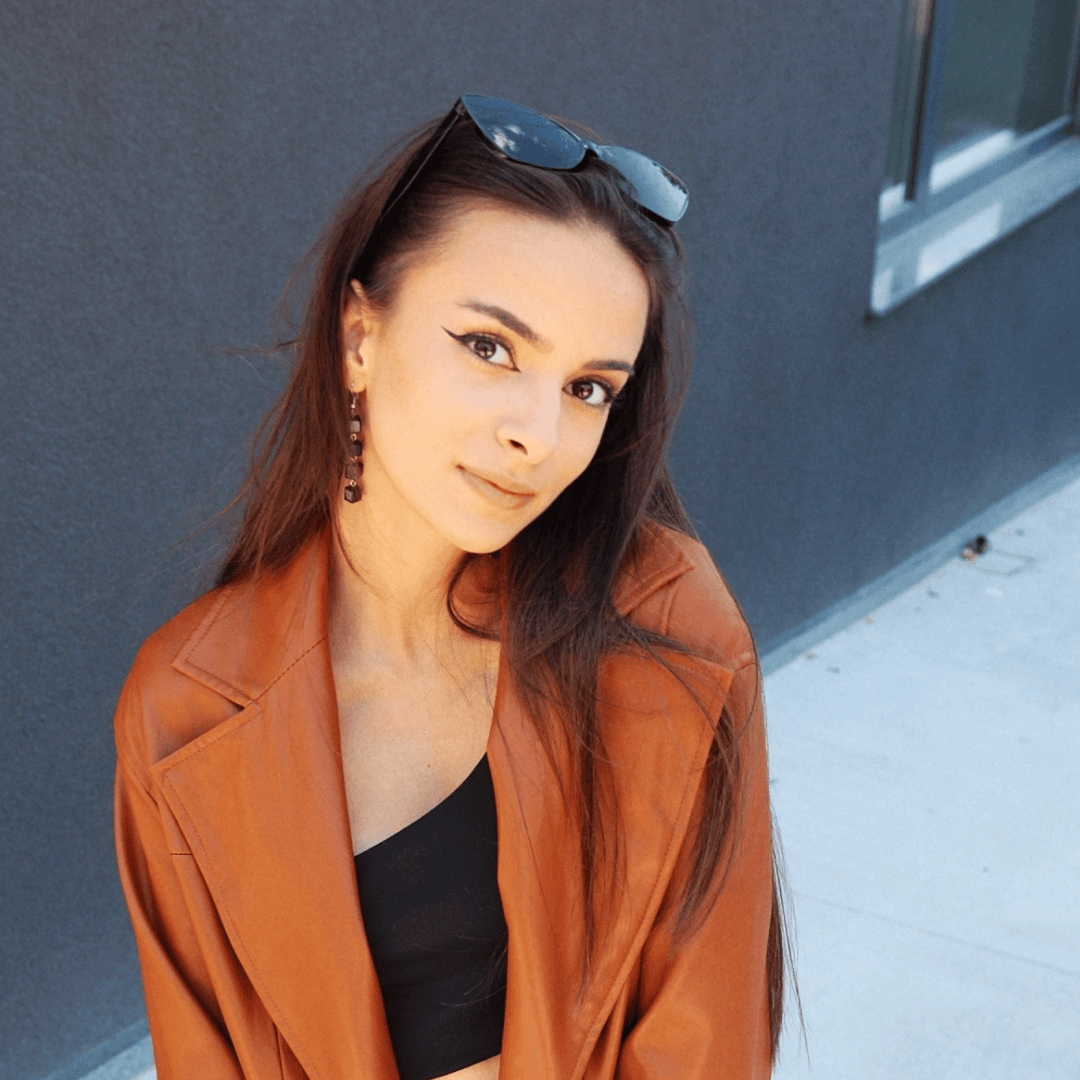 Portrait photograph of a woman with long hair, smiling.