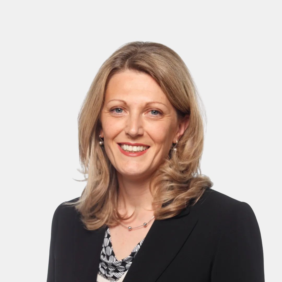 Portrait photograph of a woman with long hair, smiling.