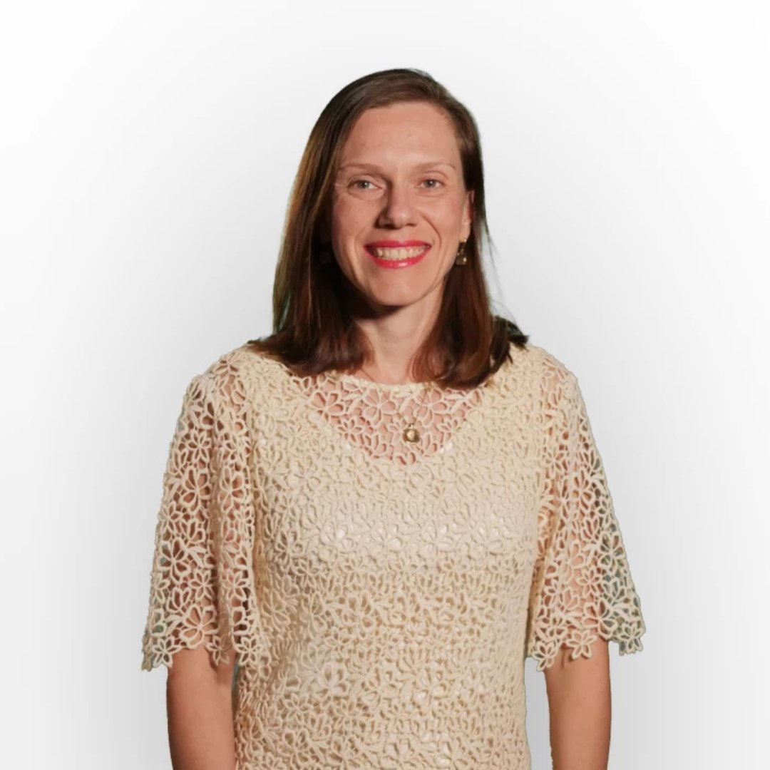 Portrait photograph of a woman with long hair, smiling.