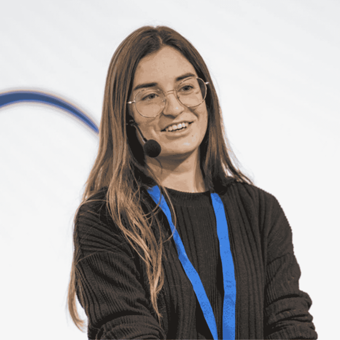 Portrait photograph of a woman with long hair, smiling.