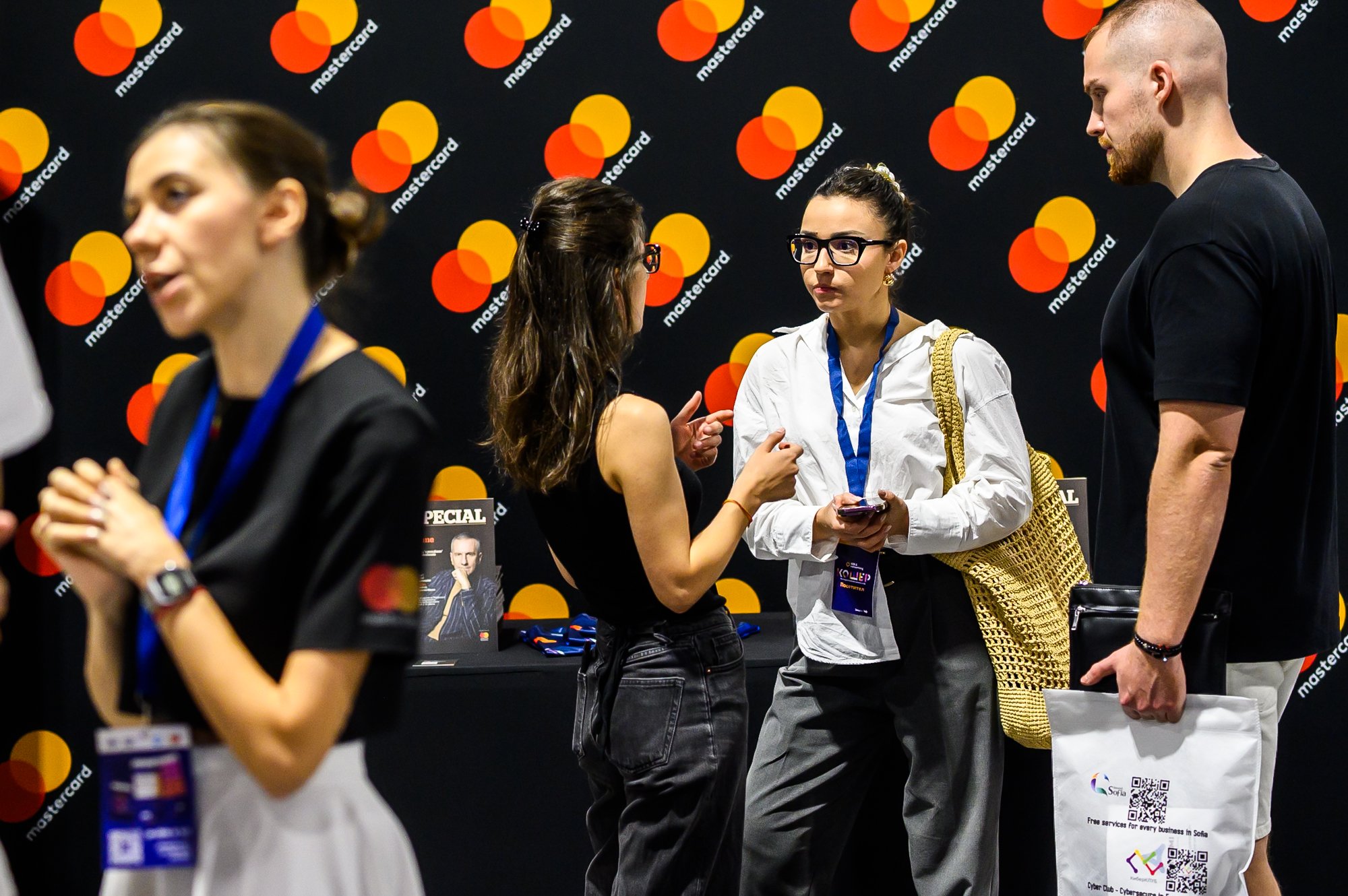 Medium shot photograph of two individuals seated, engaged in a discussion.