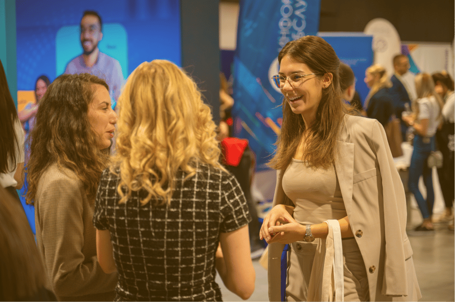 Photographic image of individuals interacting in a professional setting.