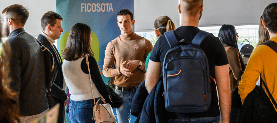 Black and white photograph of people interacting at a table.