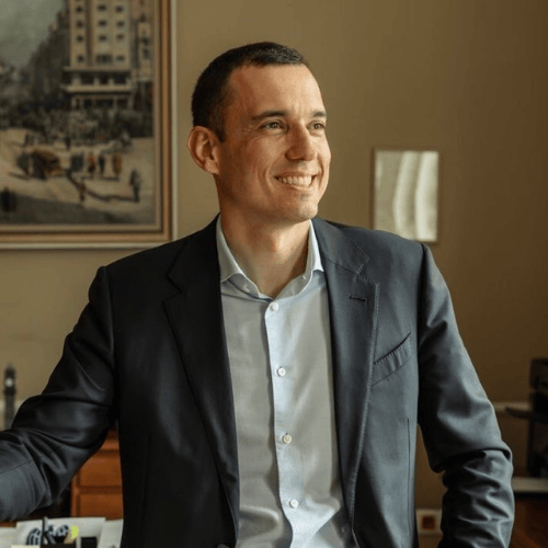 Portrait photograph of a woman with long hair, smiling.