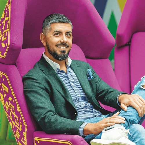Portrait photograph of a woman with long hair, smiling.