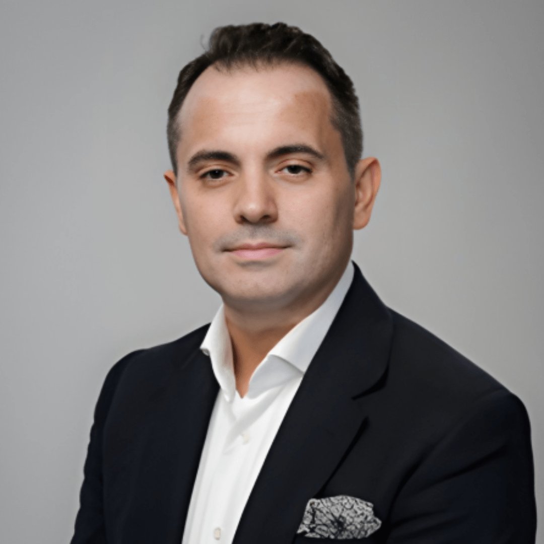 Portrait photograph of a woman with long hair, smiling.