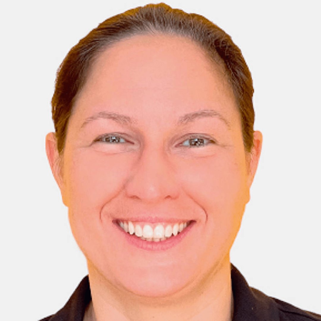 Portrait photograph of a woman with long hair, smiling.